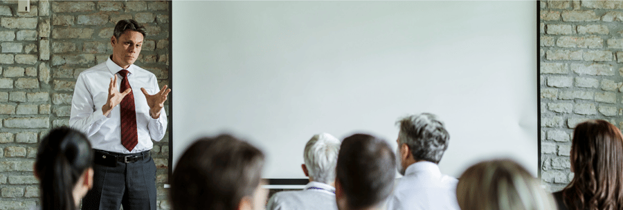 man coaching a room of teachers